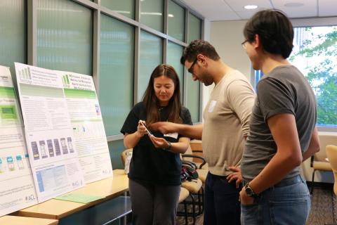 Student explaining her design poster to people